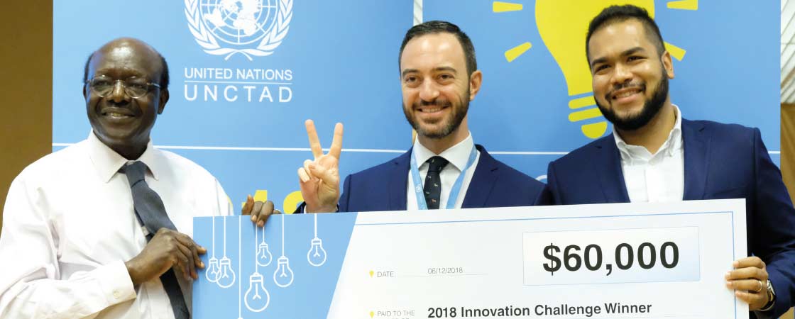 Arnau Izaguerri and William Taborda receiving top prize in UNCTAD's staff Innovation Challenge, with Secretary-General Mukhisa Kituyi