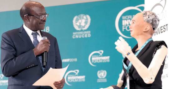 UNCTAD Secretary-General Mukhisa Kituyi, with Sophia, a talking robot.