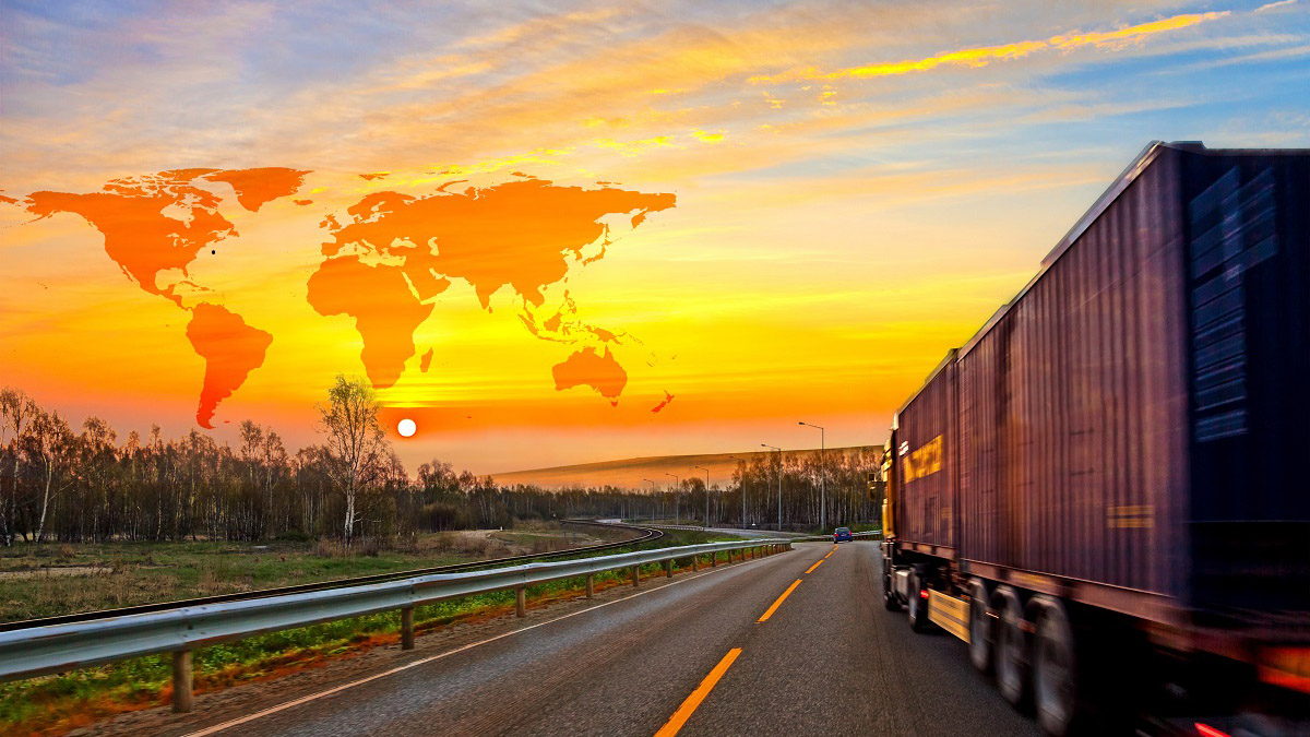 Truck driving into sunset on African road.