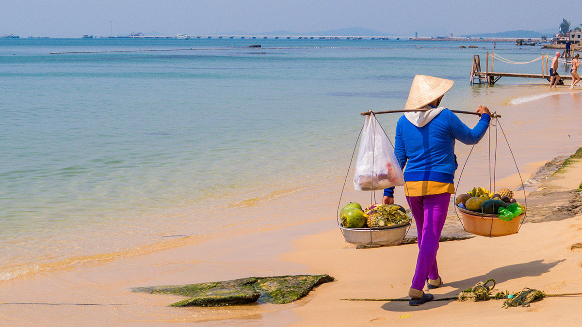 Woman trade walking on beach