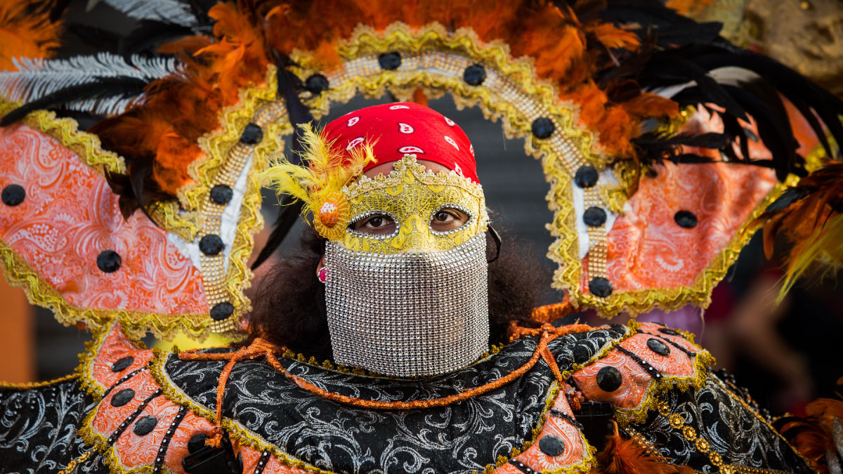 A woman wears a Motley masquerade costume in the Dominican Republic