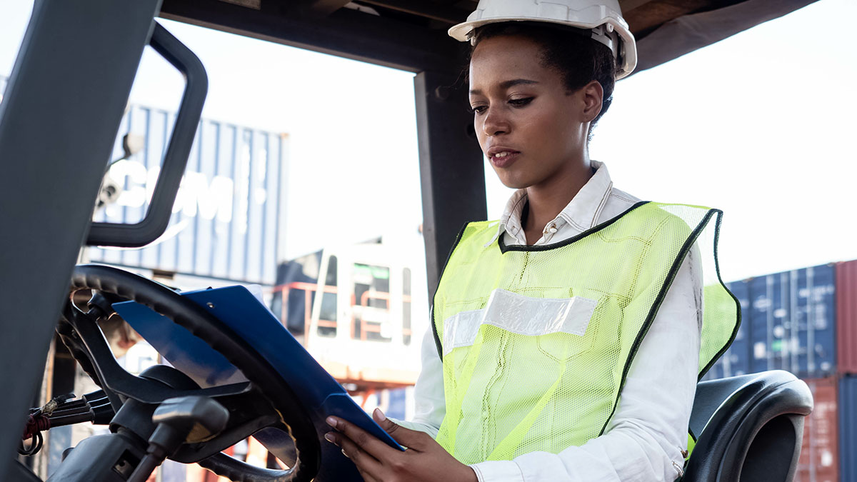 Woman forklift driver in container port