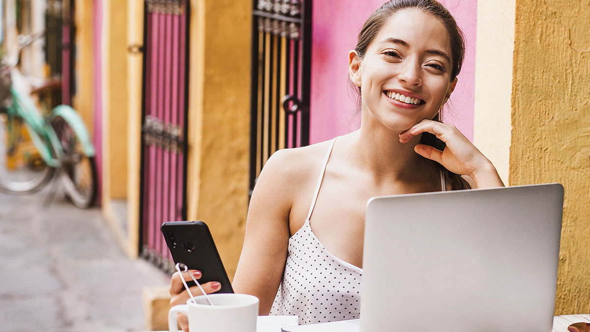 Woman remote learning at street side cafe