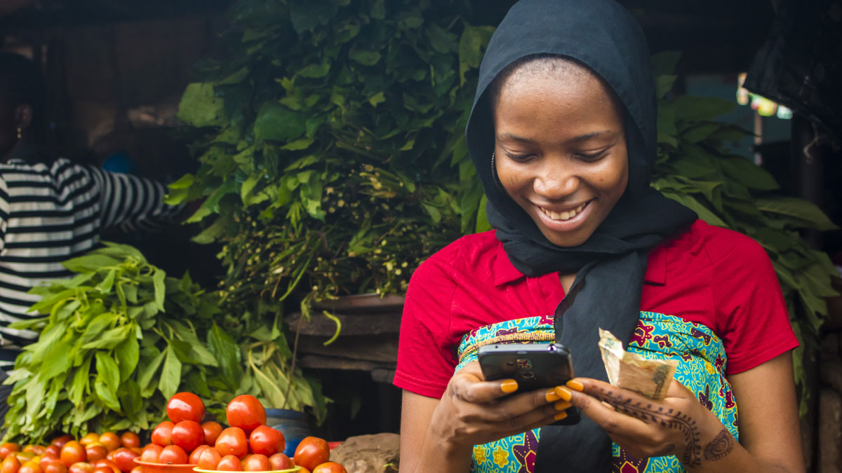 A woman conducts a financial transaction on phone