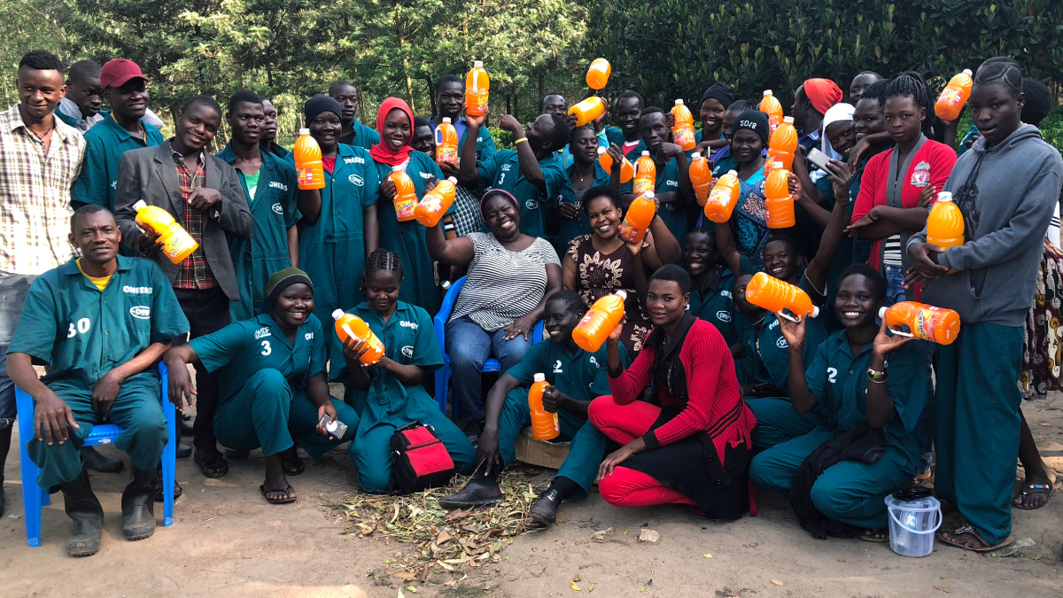 Julian Omalla with Cheers employees at her juice factory