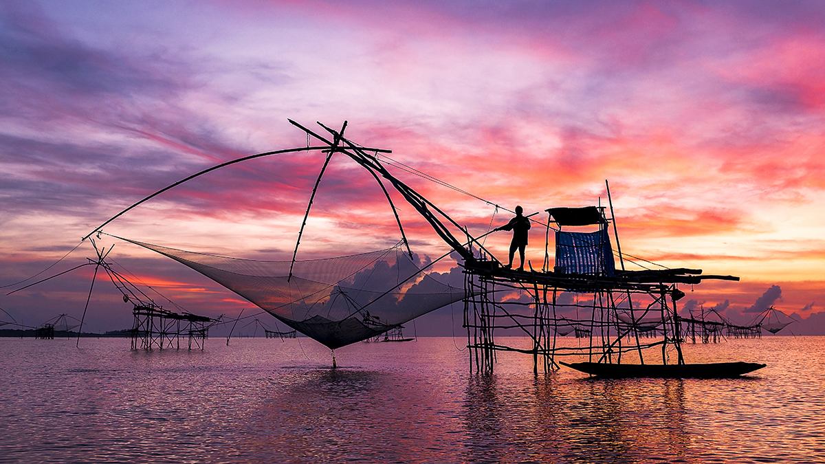 Indigenous fisherman fishing on ocean