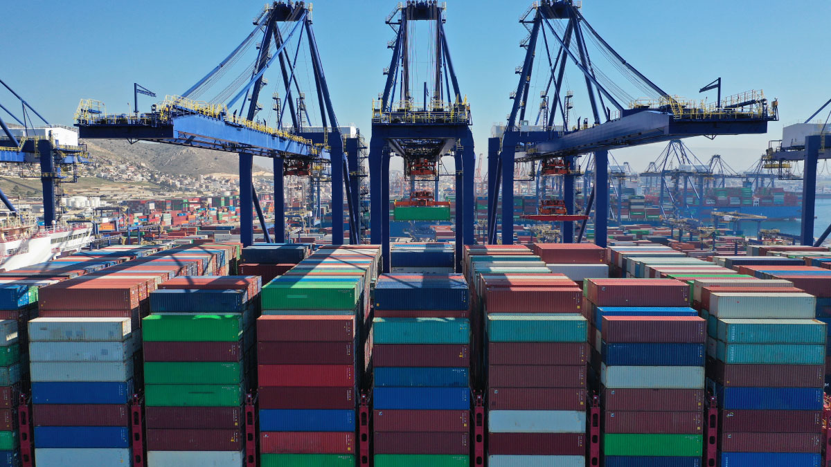 Cranes loading containers on a vessel in a port