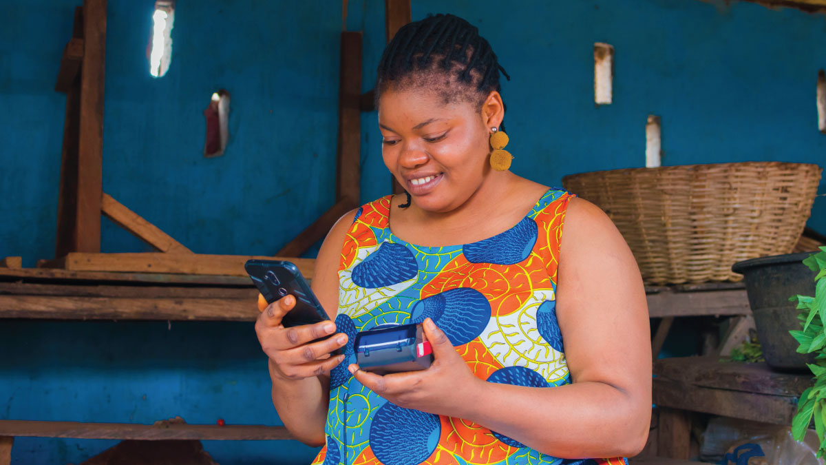 An African woman entrepreneur uses a digital payment device