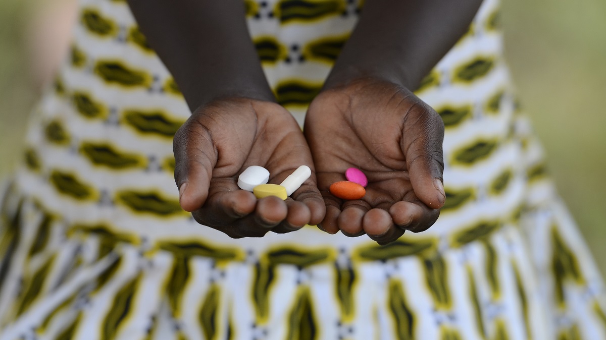 An African girl holds counterfeit medicines in her hands