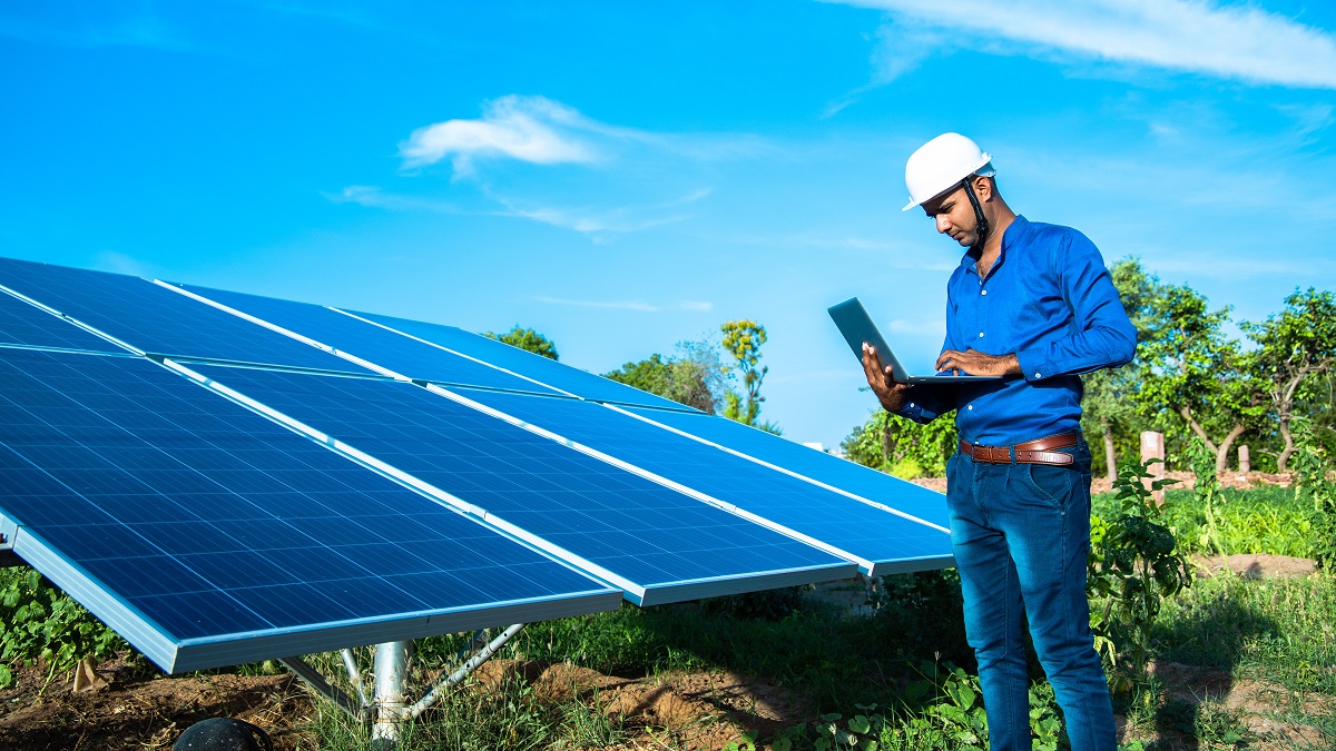 An engineer works on an agrivoltaic solar farm.