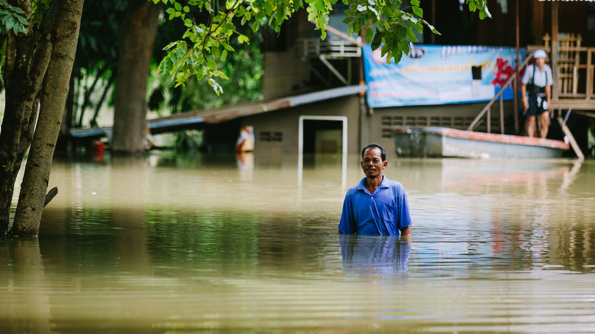 A man in flooded waters in Thiland