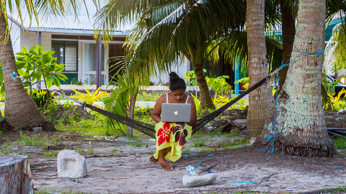 Woman in a hammock with a notebook