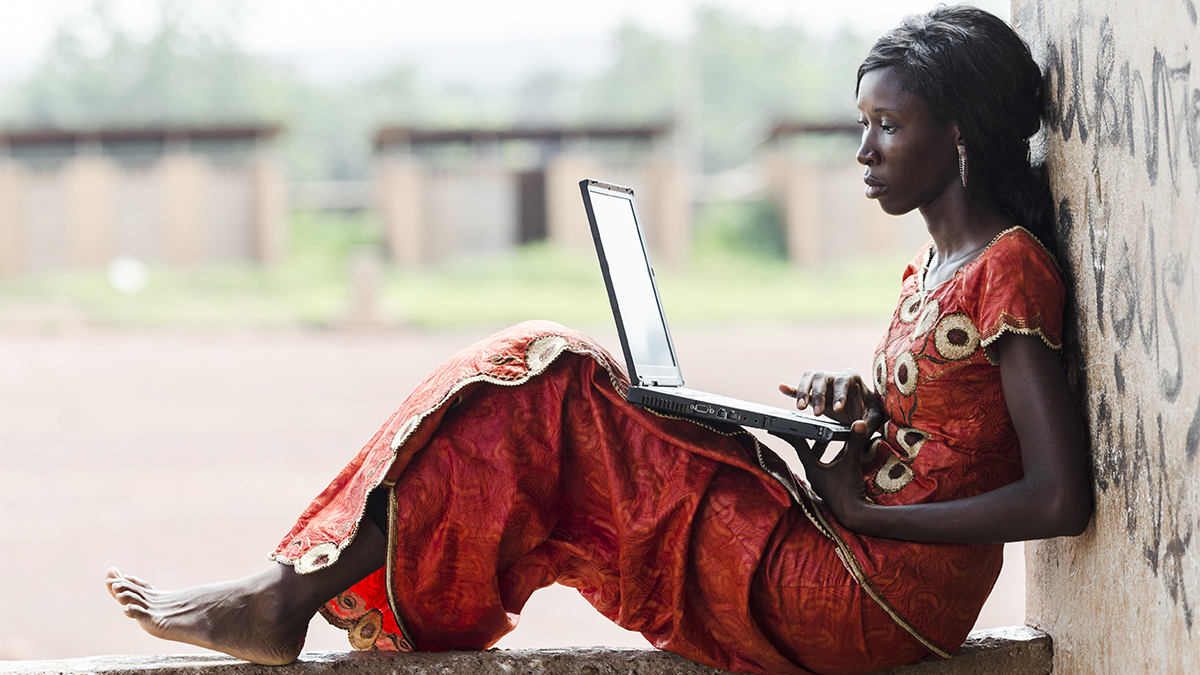 Digital Economy - African woman working on her laptop computer