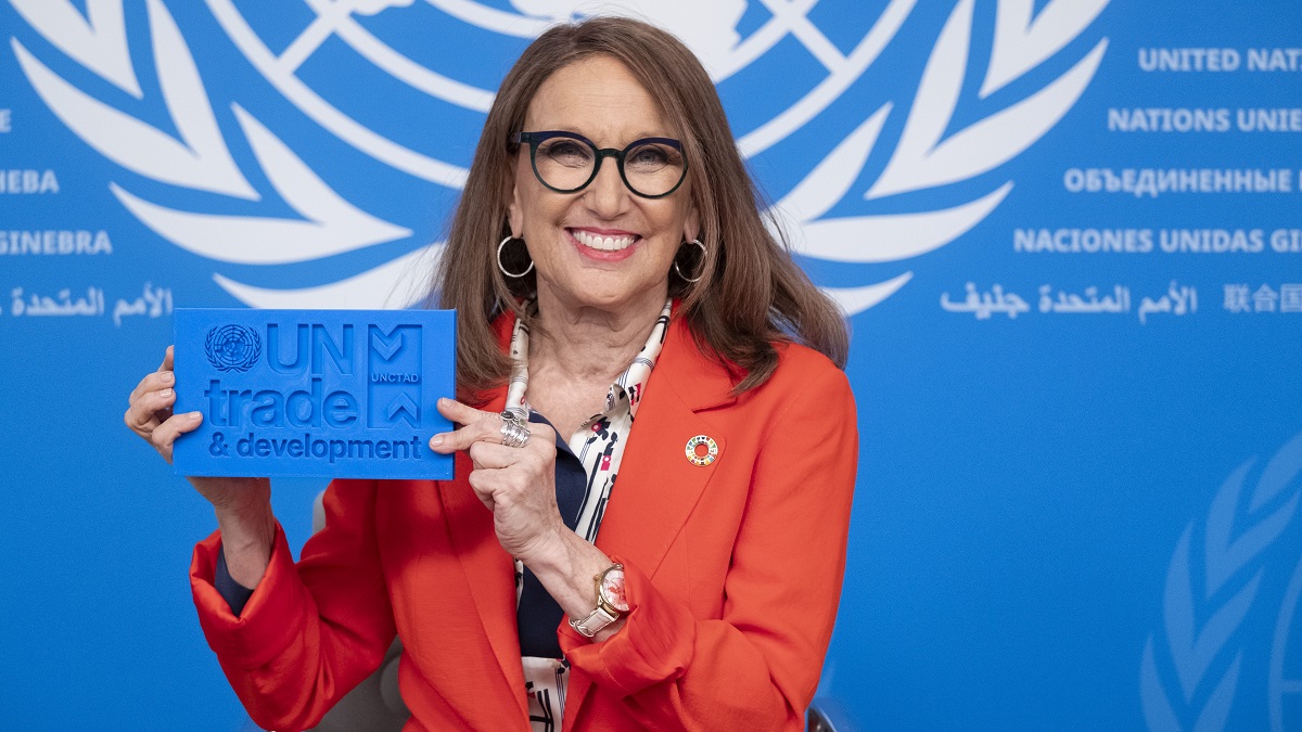 UN Trade and Development Secretary-General Rebeca Grynspan holds the organization's new logo