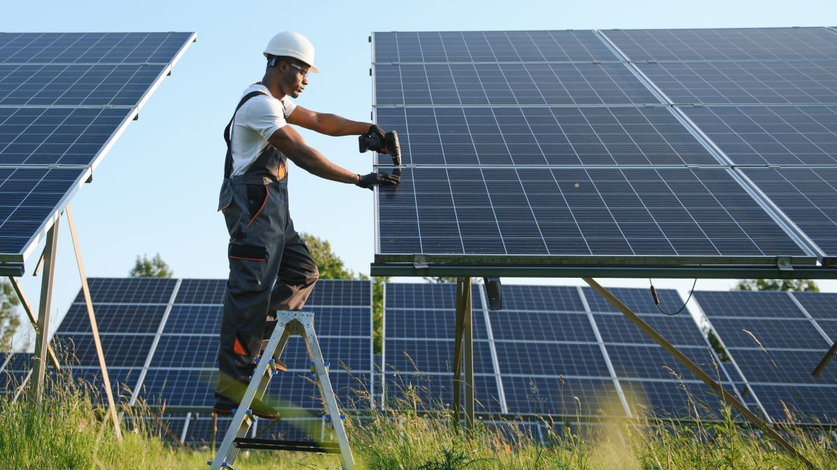 A worker installs solar panels