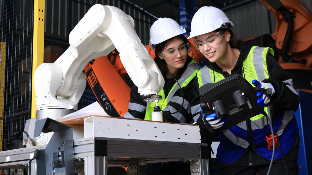 Engineers test an AI-driven robotic arm in a modern factory.