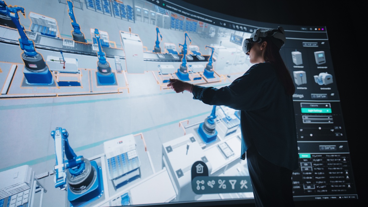 An engineer uses virtual reality to optimize production flows in a simulated factory.