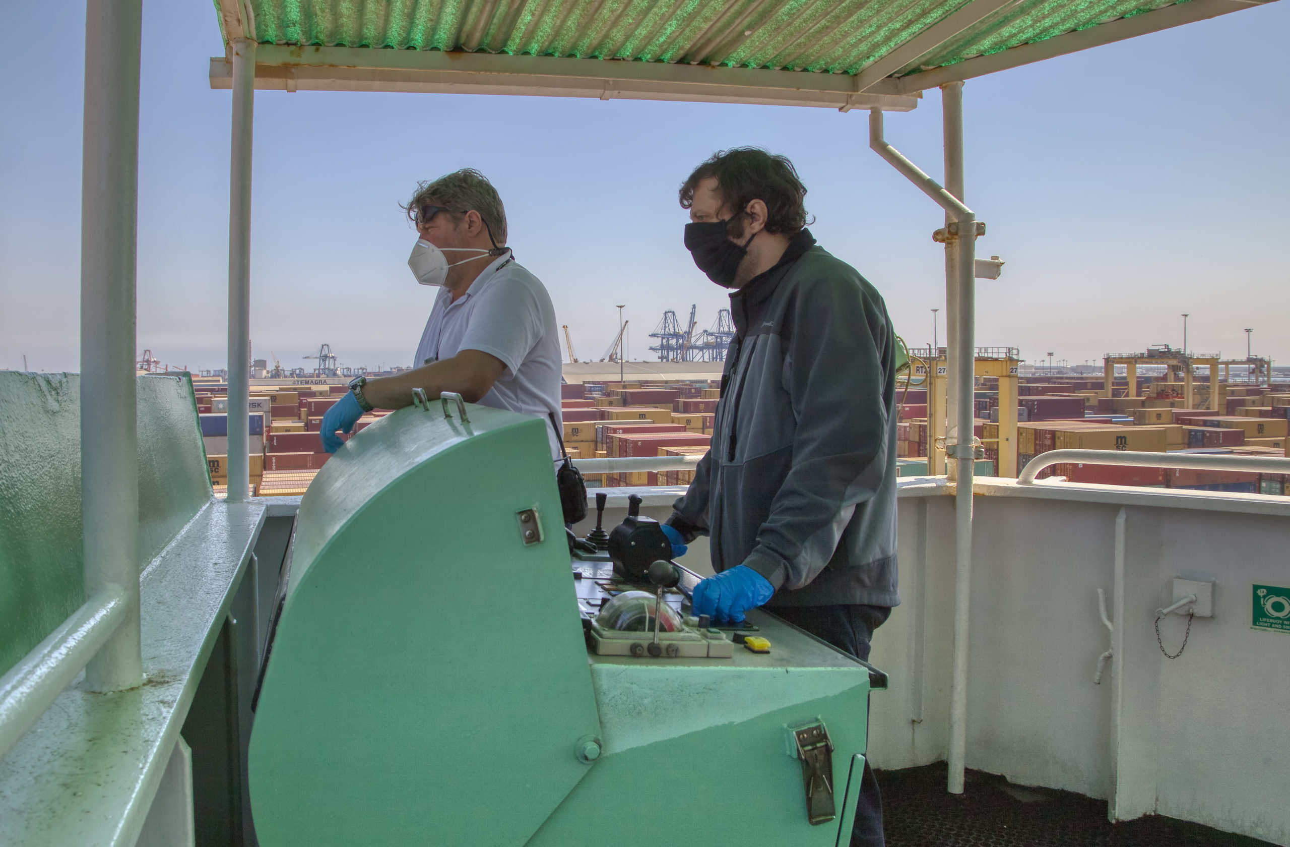 Workers in the Port of Valencia, Spain, wearing a COVID-19 mask