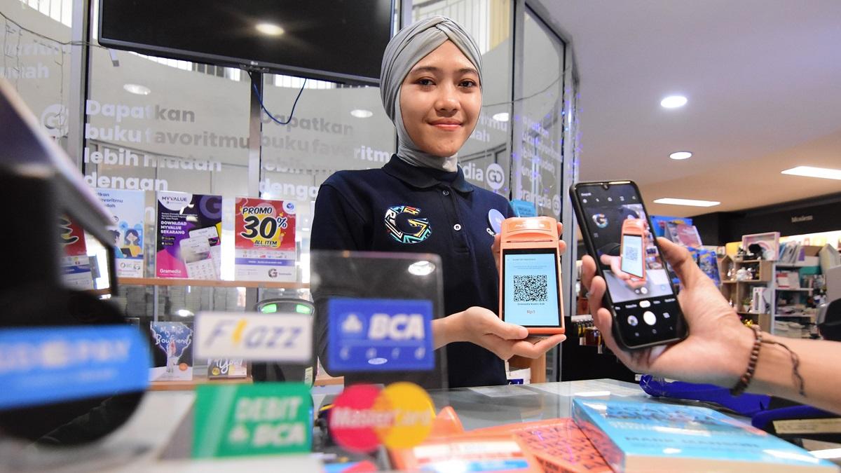 A customer uses digital payment at a bookstore in Gramedia Kediri, Indonesia.