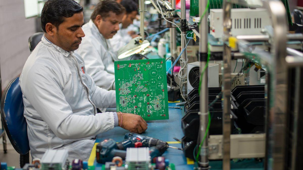 An engineer making circuit boards in a factory.