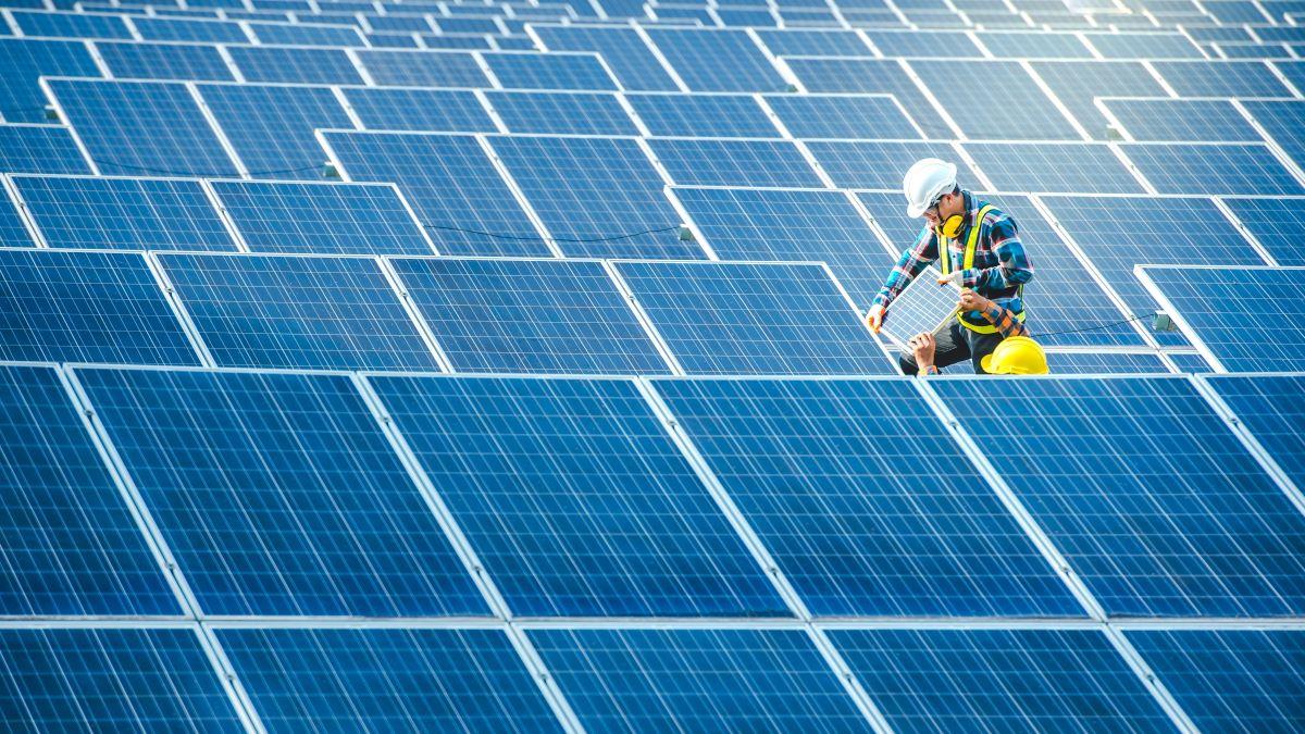 A worker inspects solar panels