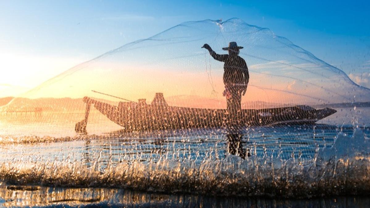 A fisherman casts a net.