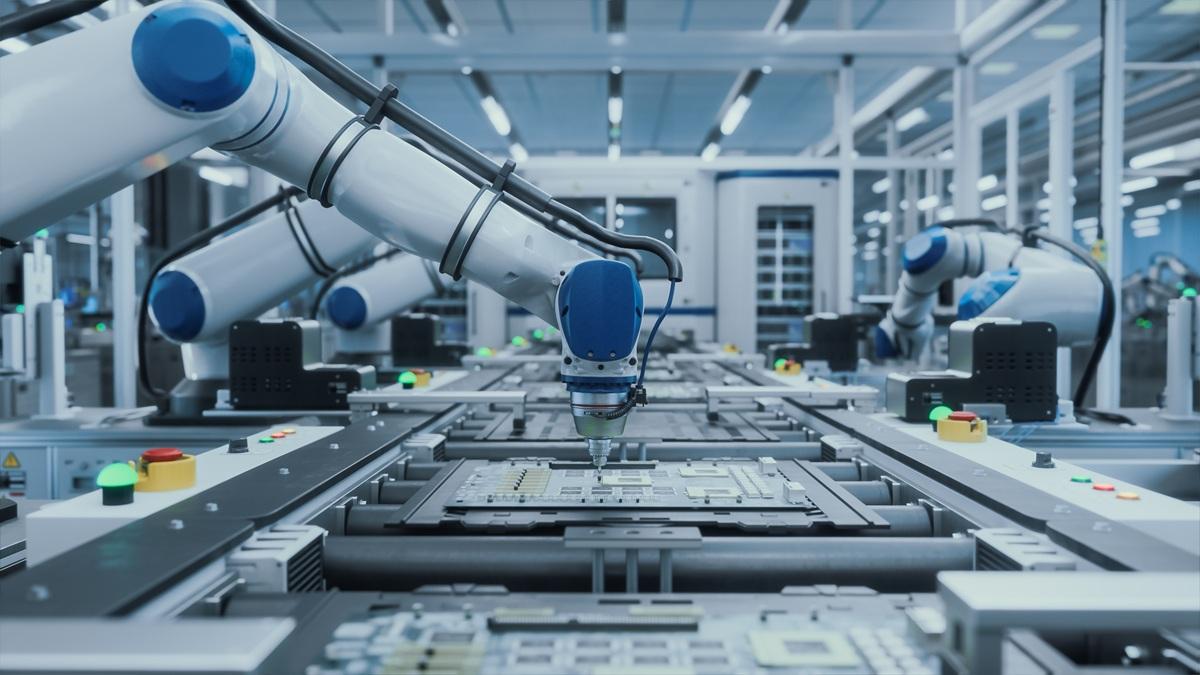 Automated robotic arms assemble circuit boards at an advanced manufacturing plant.