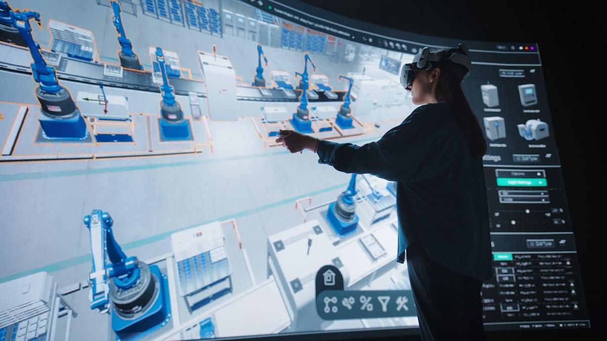 An engineer uses virtual reality to optimize production flows in a simulated factory.