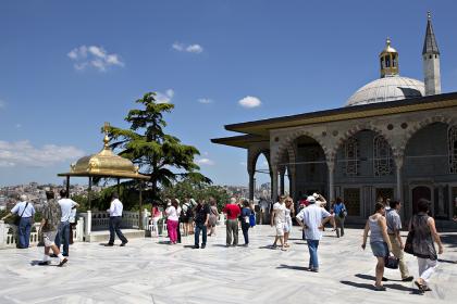Iraqi people walk around historical site