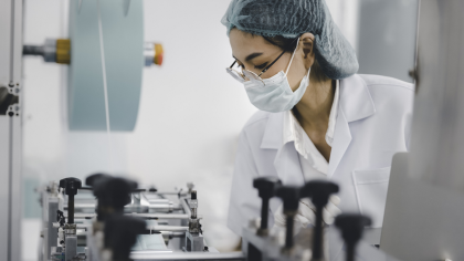 Female engineer working at clean medical mask production factory