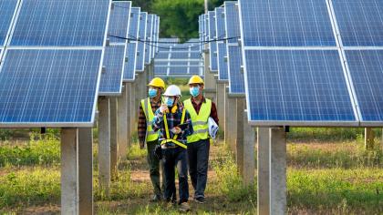 Workers inspect a solar power plant