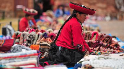 Women sell Andean textile products at a market in Chinchero, Peru.
