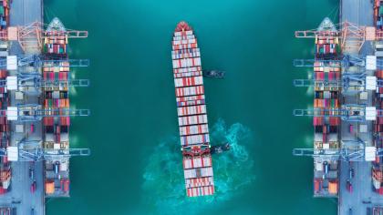 An aerial view of a container vessel leaving port