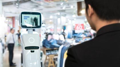 A customer interacts with an artificial intelligence robot in a shopping mall.