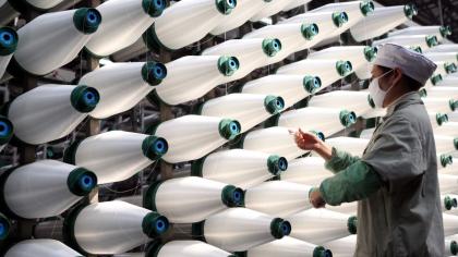 A worker produces glass fiber at an industrial park in Jiangxi, eastern China