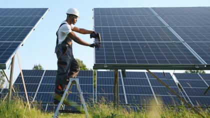 A worker installs solar panels