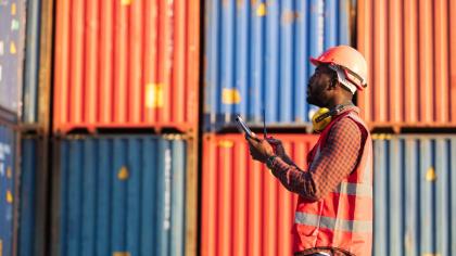 A worker in a port inspects containers